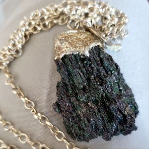 Tourmaline gemstone mounted on 20" drop chain. Silvertone
